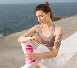 young thoughtful woman in sporty top and white leg XYCRPQT